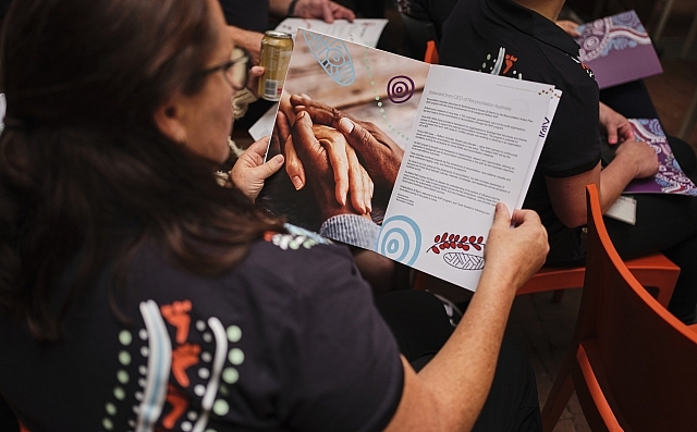 221110_St Barts_RAP Launch_082 Person reading a brochure at RAP launch